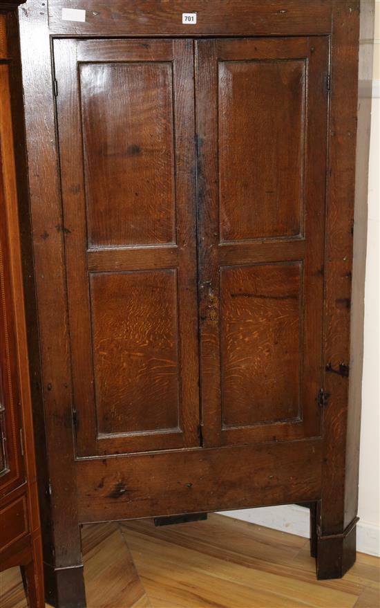 An 18th century oak standing corner cupboard, W155cm